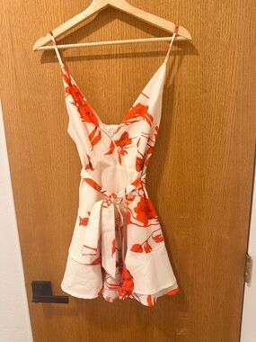 Luxxel White Romper with Bold Orange Floral Print